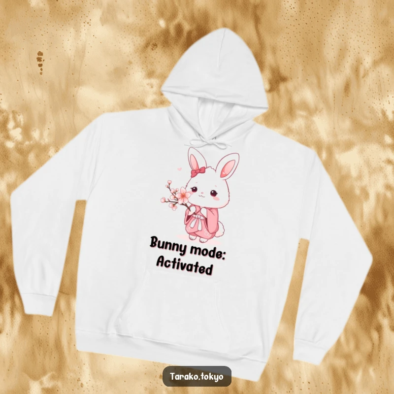 Funny Hoodie depicting a fluffy bunny wearing a traditional pink kimono, holding a single cherry blossom, cozy and kawaii.
