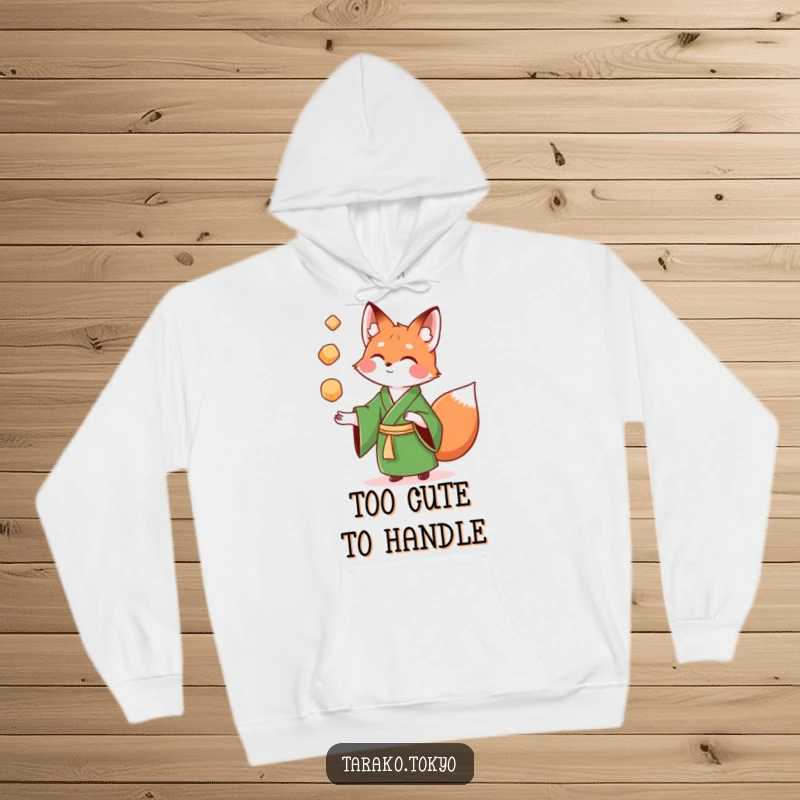 Funny Hoodie showcasing a playful fox in a green kimono enthusiastically juggling many colorful mochi balls, high-spirited.