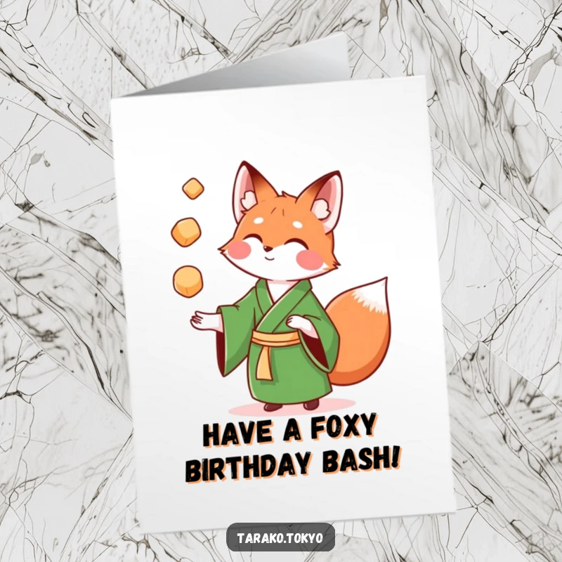 Funny Free Printable Birthday Card: Playful fox in green kimono juggles colorful mochi, wishing a fun and festive birthday with humor.